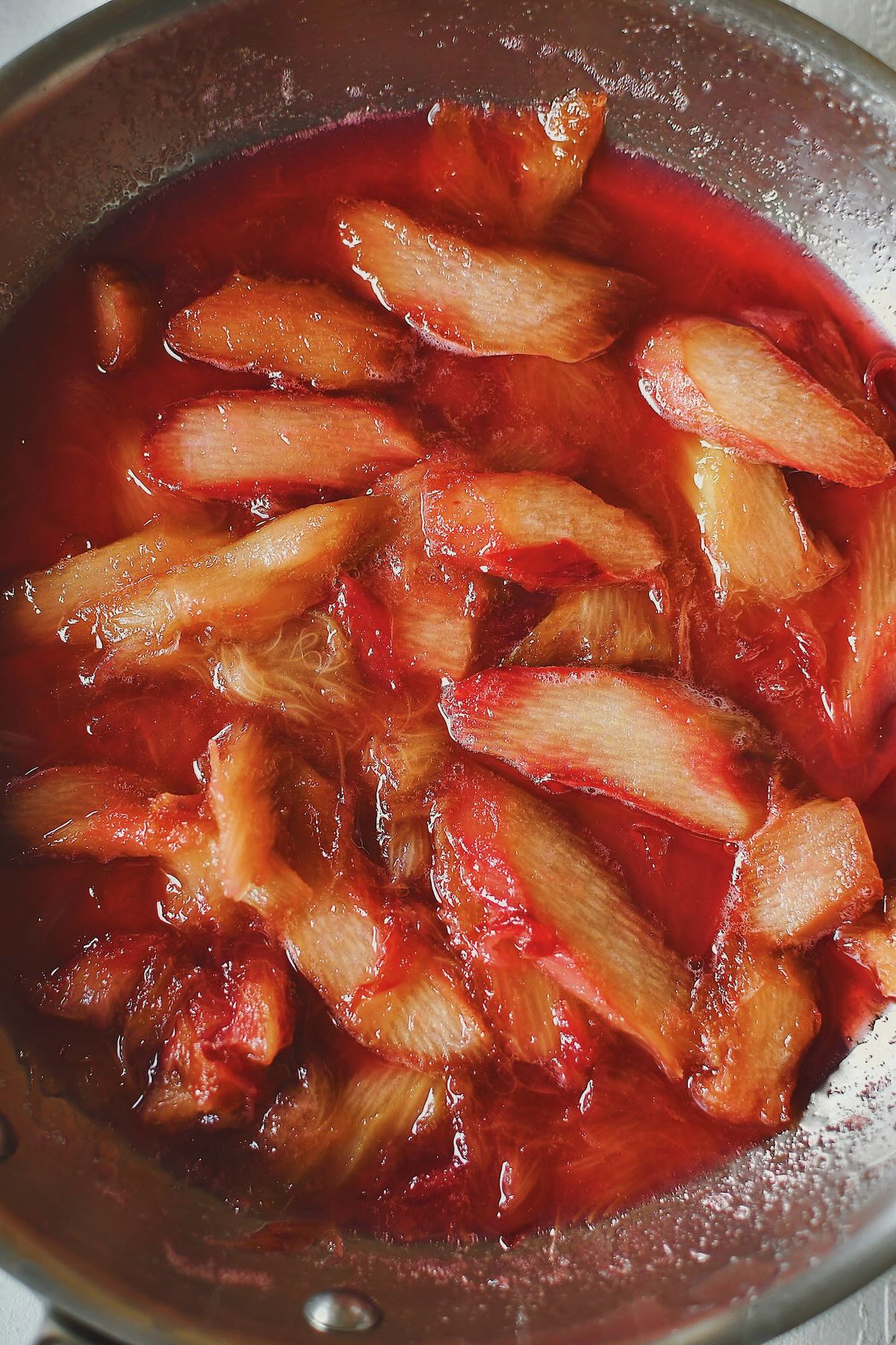 Rhubarb cooking in a skillet with lemon juice and sugar just till the sugar dissolved.
