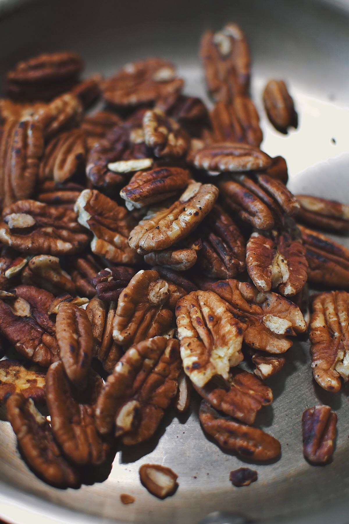 Toasting pecans in a skillet.