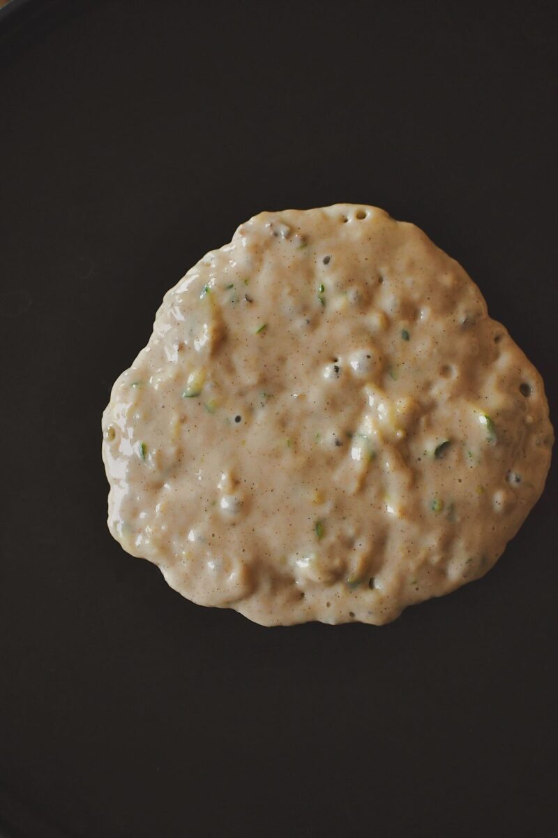 Zucchini Bread Pancake cooking on the griddle.