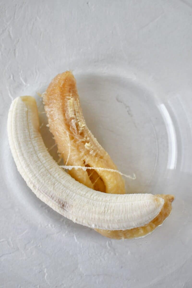 1 extremely ripe, and 1 slightly less ripe banana in a large bowl ready to be mashed.