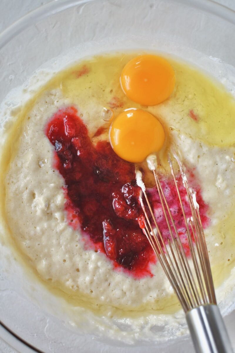 Whisking together the pancake batter and adding in the eggs and some of the jammy plums.