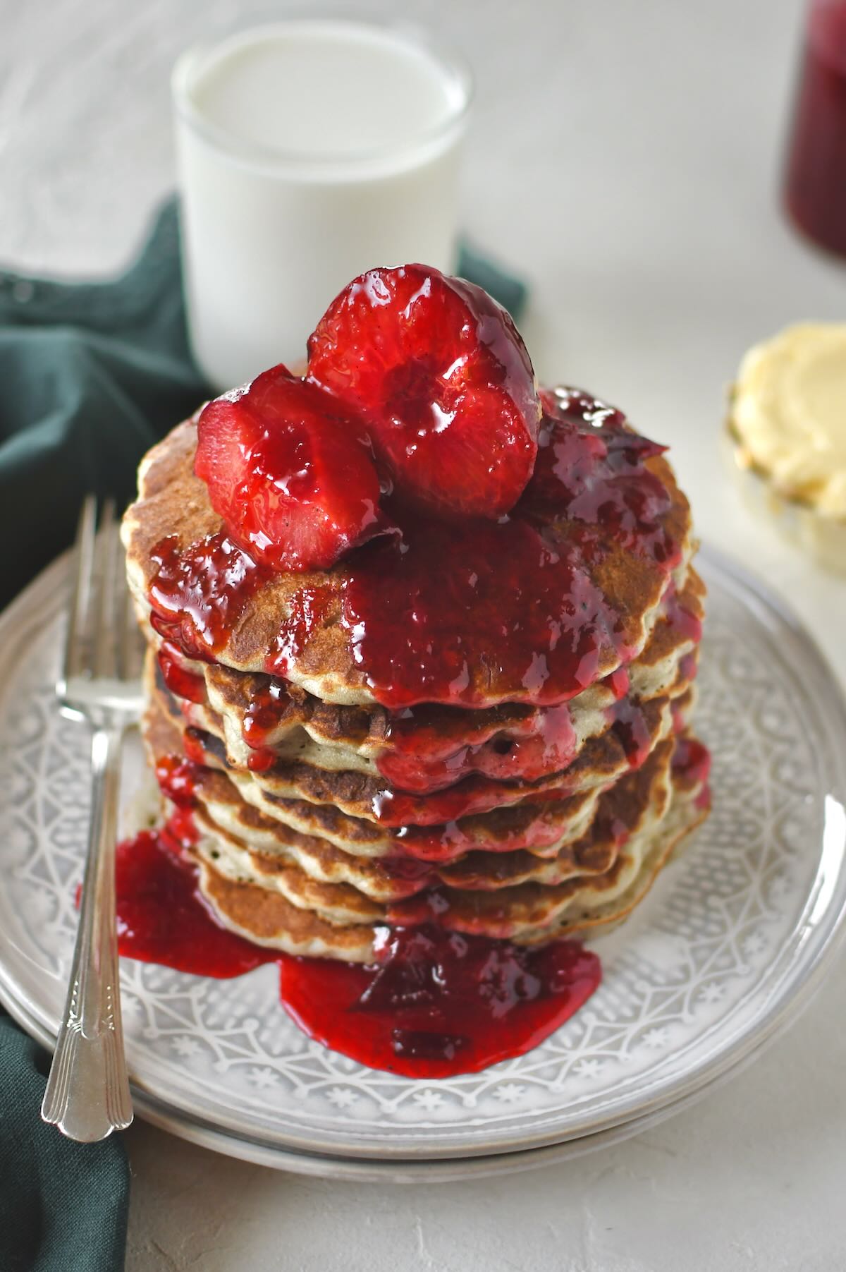 Plum Pancakes stacked high and topped the jammy plums as a syrup for them.