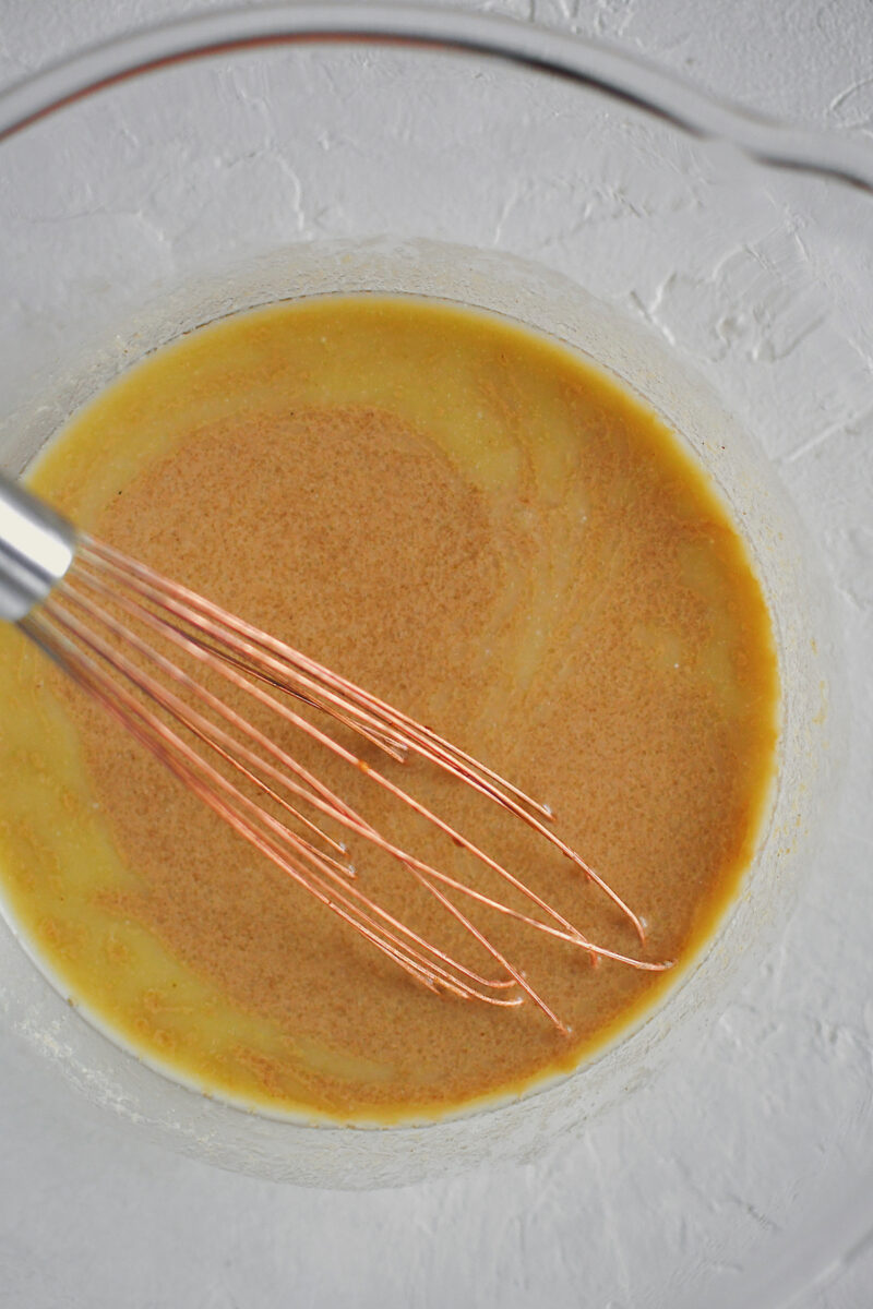 Melted butter and warmed milk in a bowl with the boiled apple cider, before adding the dry ingredients.