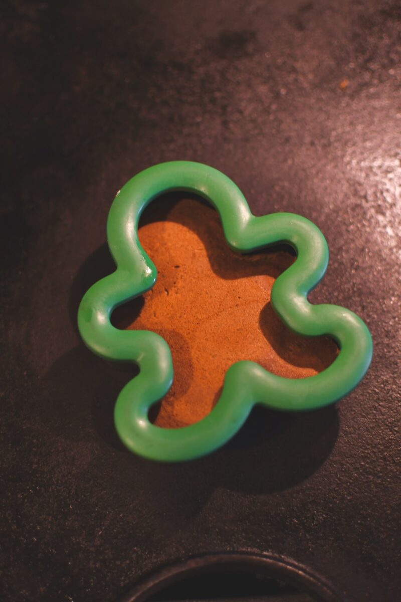 Cooking a gingerbread pancakes in a metal gingerbread man cookie cutter.