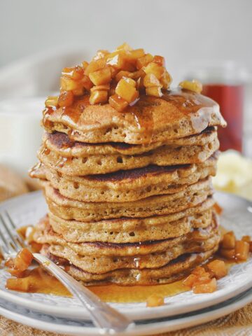 Cinnamon Apple Pancakes, stacked seven high and topped with the cinnamon apple topping.